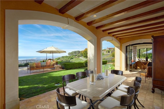 view of patio / terrace with an outdoor bar, a water view, and outdoor lounge area