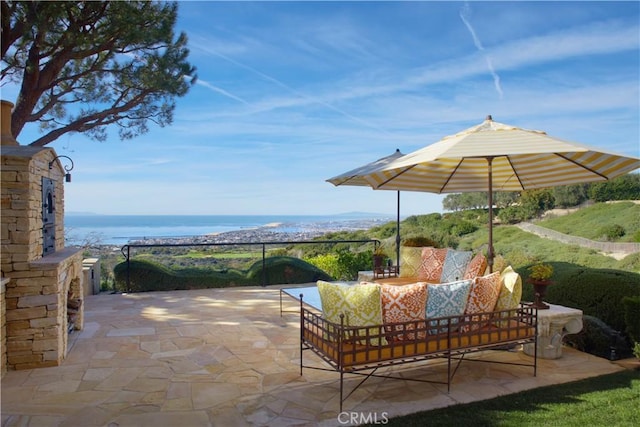 view of patio / terrace featuring a water view and an outdoor hangout area