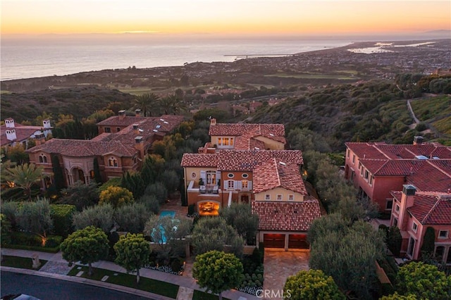 aerial view at dusk with a water view