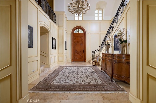 entrance foyer with a notable chandelier and a towering ceiling