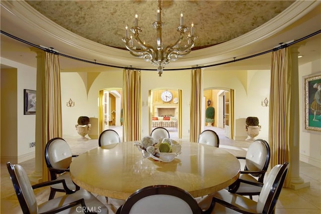 dining room with light tile patterned floors, a notable chandelier, and crown molding