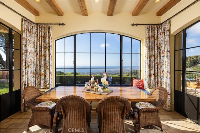 dining area with beam ceiling