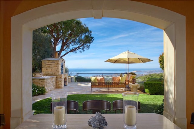 view of patio featuring an outdoor living space and a water view