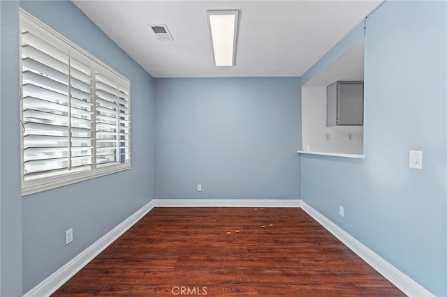 unfurnished room featuring dark wood-type flooring