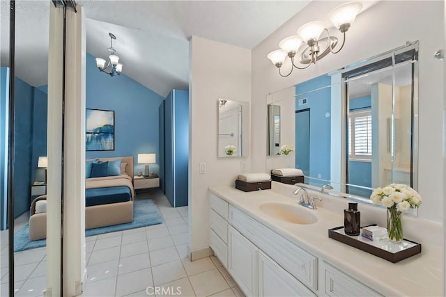 bathroom featuring an inviting chandelier, vaulted ceiling, tile patterned floors, and vanity