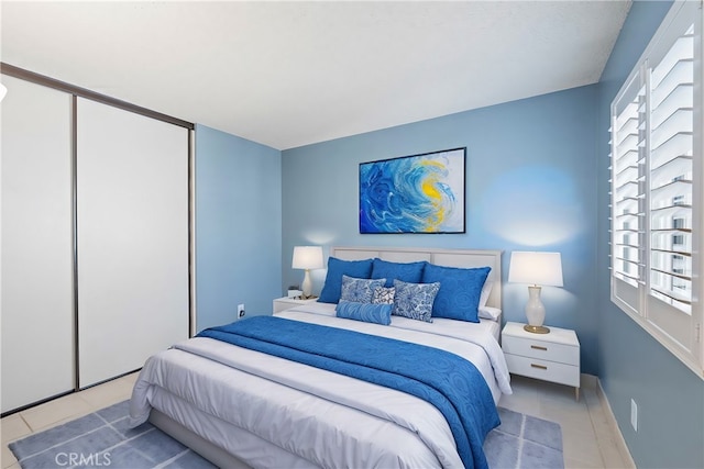 bedroom featuring light tile patterned flooring and a closet