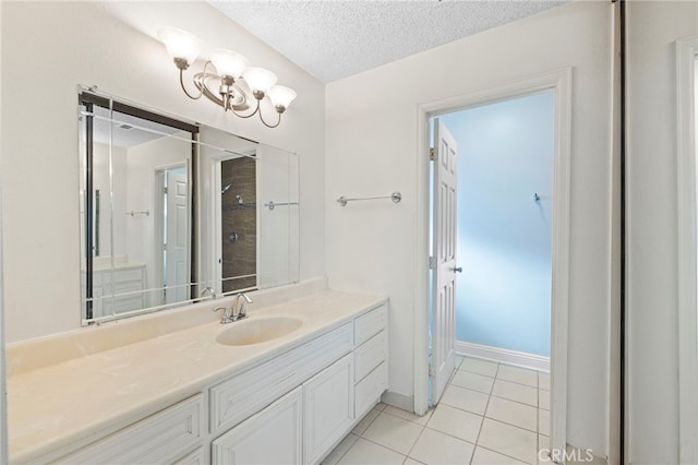 bathroom featuring a textured ceiling, vanity, a shower, and tile patterned floors