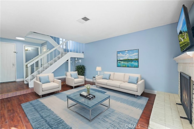 living room with hardwood / wood-style floors and a fireplace