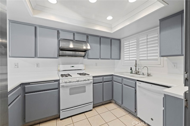 kitchen with white appliances, gray cabinets, a raised ceiling, and sink