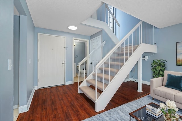 stairway featuring wood-type flooring