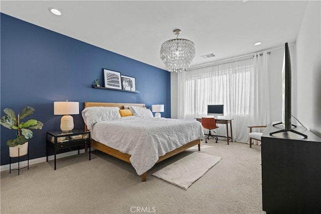 bedroom featuring carpet floors and a chandelier