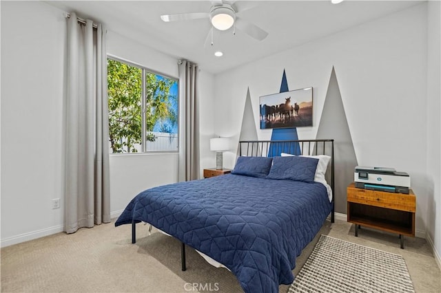 bedroom featuring light colored carpet and ceiling fan