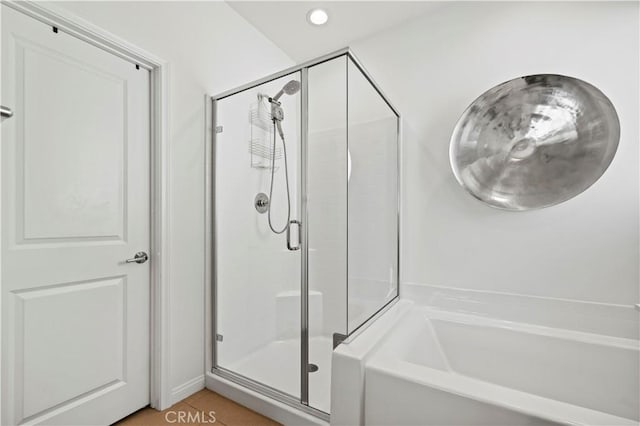 bathroom with separate shower and tub and tile patterned floors