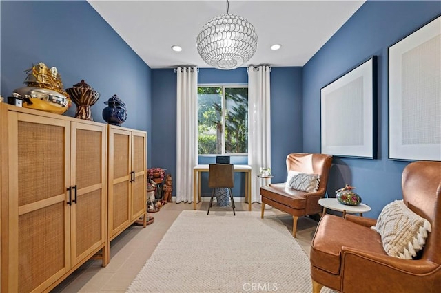 sitting room with a chandelier and decorative columns