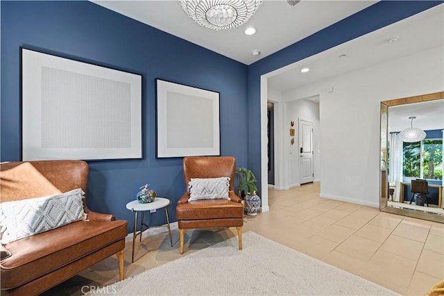 living area featuring a chandelier