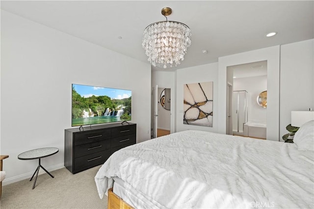 carpeted bedroom featuring a notable chandelier and ensuite bathroom