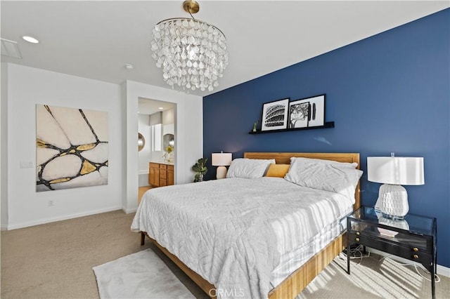 carpeted bedroom featuring a chandelier and connected bathroom