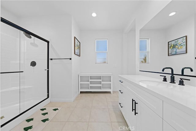 bathroom with walk in shower, tile patterned floors, and vanity