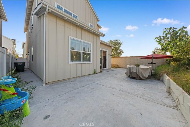 view of side of property with a patio area