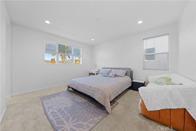 bedroom with multiple windows and light carpet