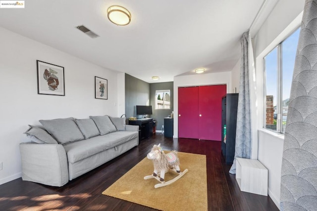 living room with radiator and dark wood-type flooring