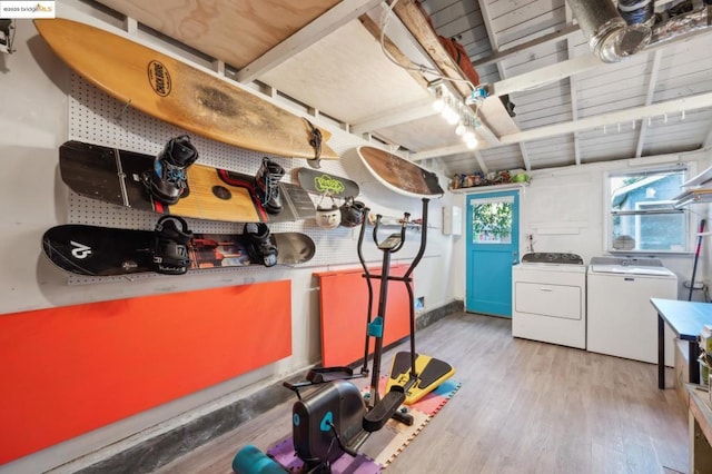 basement featuring separate washer and dryer and light hardwood / wood-style flooring