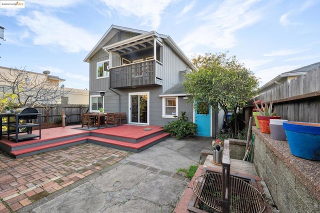 back of house with a patio area, a deck, and a balcony