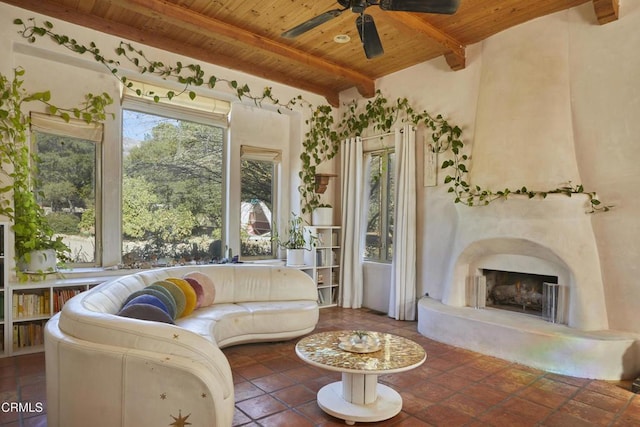 living room with a high end fireplace, wooden ceiling, a healthy amount of sunlight, and beam ceiling