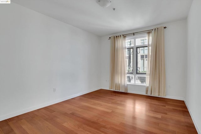 unfurnished room with wood-type flooring