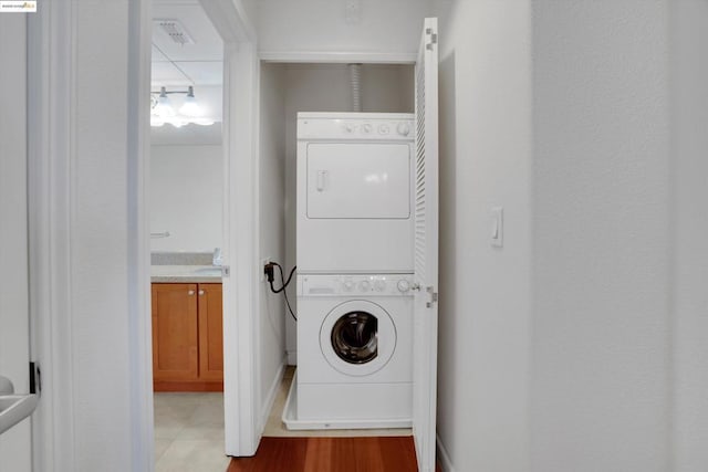 laundry room with stacked washing maching and dryer