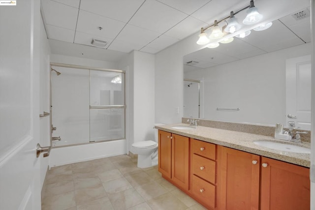 full bathroom with toilet, bath / shower combo with glass door, and vanity