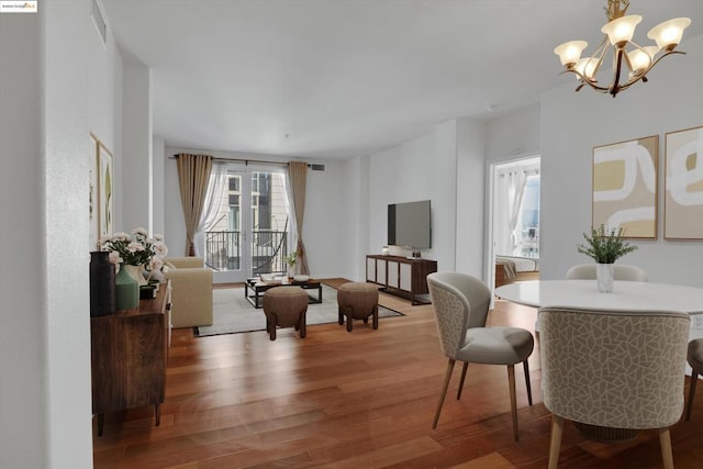 interior space featuring an inviting chandelier and hardwood / wood-style floors