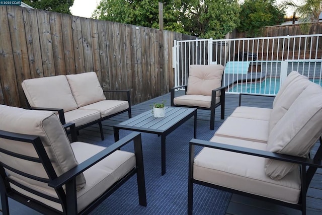 view of patio / terrace featuring a fenced in pool and an outdoor living space