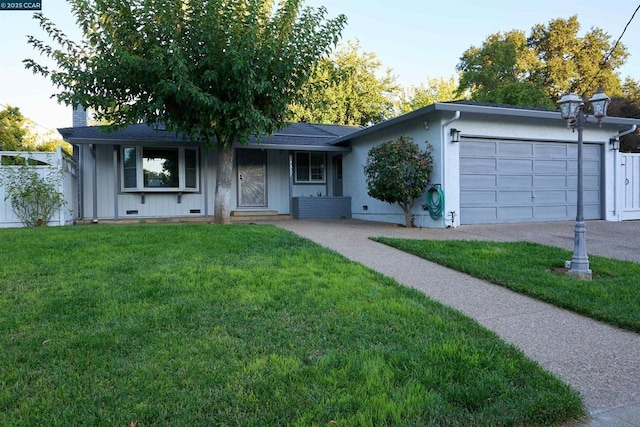 single story home with a front yard and a garage