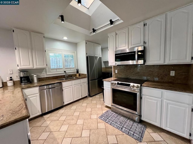 kitchen featuring white cabinets, stainless steel appliances, and sink