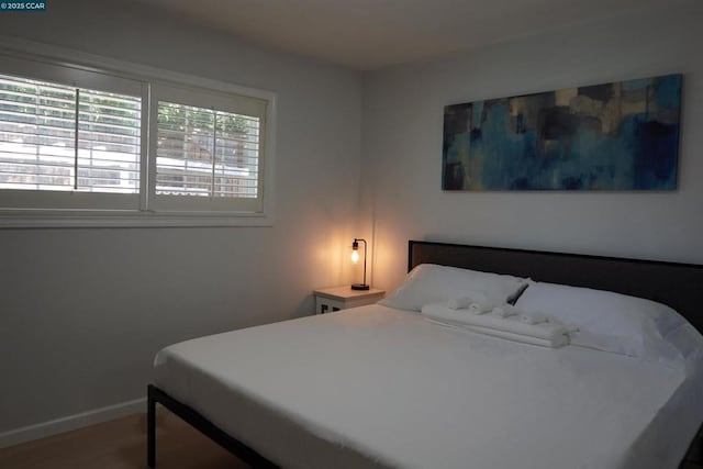 bedroom with hardwood / wood-style floors