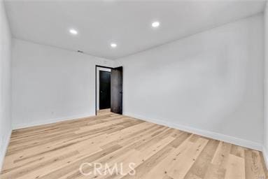 unfurnished room with hardwood / wood-style floors