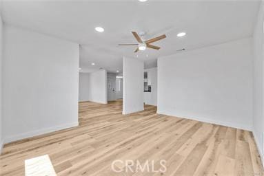 unfurnished living room with ceiling fan and light hardwood / wood-style flooring