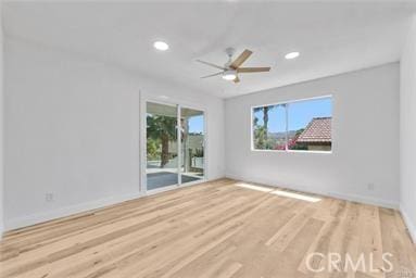 unfurnished room with ceiling fan and hardwood / wood-style flooring