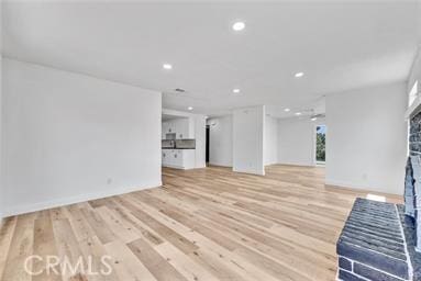 unfurnished living room with light hardwood / wood-style flooring