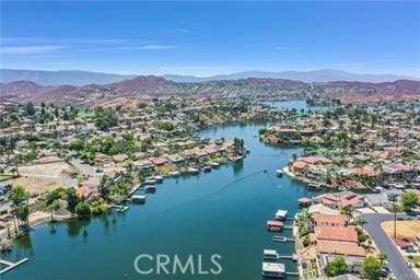 birds eye view of property with a water and mountain view