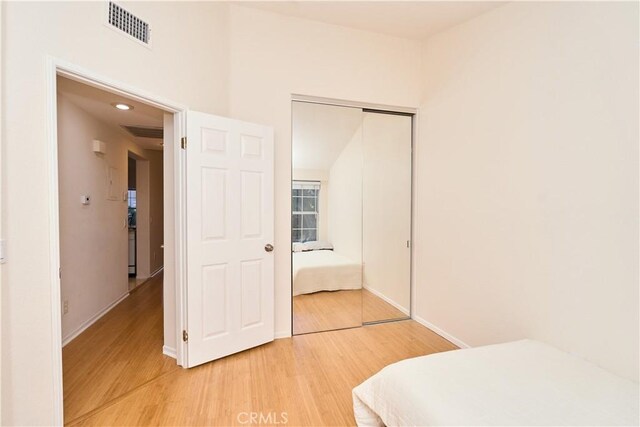 bedroom featuring a closet and hardwood / wood-style floors