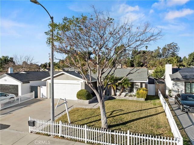 view of front of property with a garage and a front lawn