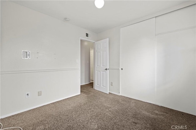 unfurnished bedroom with carpet and a closet