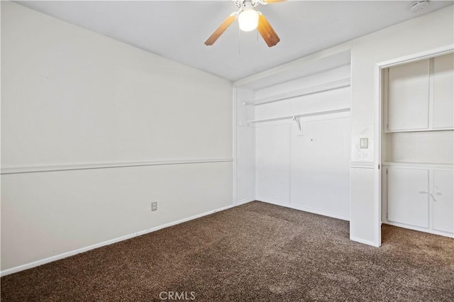 unfurnished bedroom with dark carpet, a closet, and ceiling fan