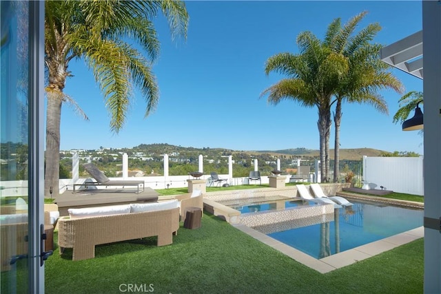 view of pool featuring an in ground hot tub, a yard, and a mountain view