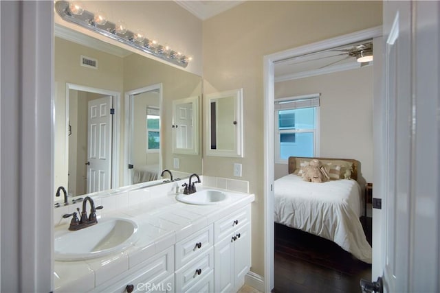 bathroom with vanity, ceiling fan, and ornamental molding