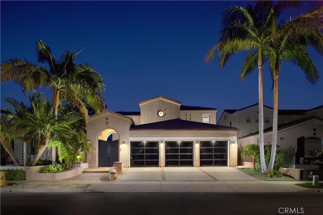 mediterranean / spanish-style home featuring a garage