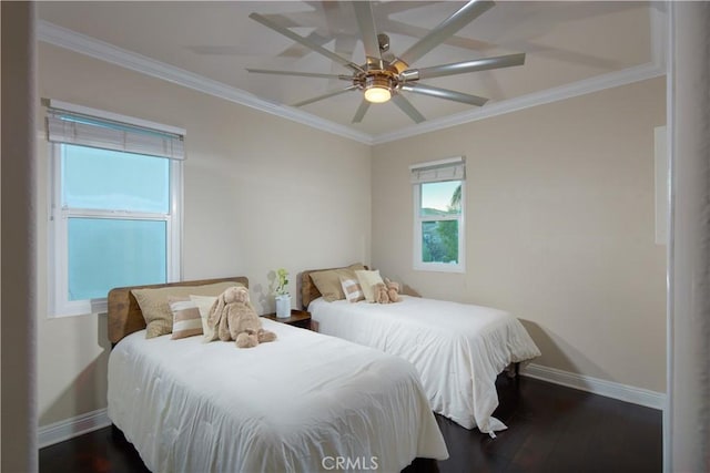 bedroom featuring dark hardwood / wood-style flooring, ceiling fan, and ornamental molding