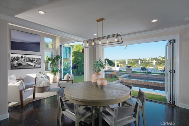 dining space featuring dark wood-type flooring and crown molding